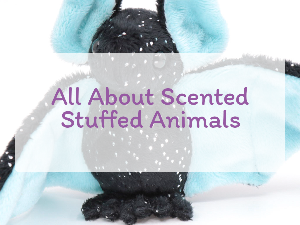 The text "All About Scented Stuffed Animals" on a 50% white background on top of an image of a black and sparkle bat with light blue inner wings and ears.