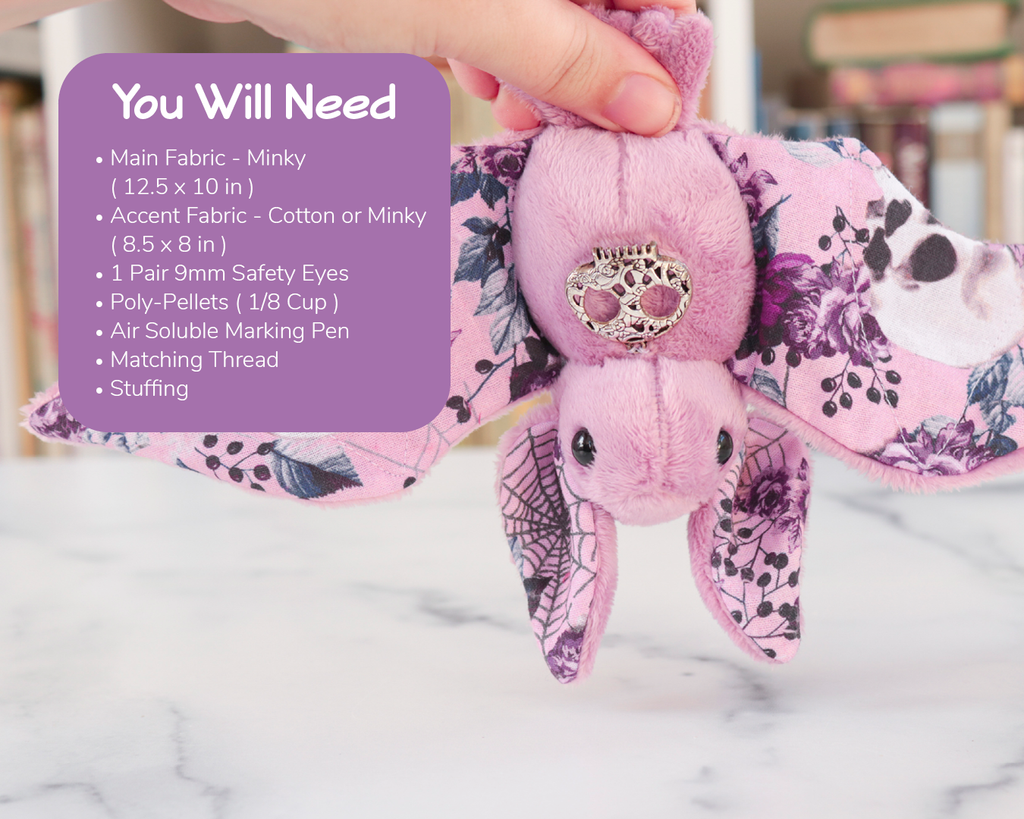 A person's hand holding a pink bat with floral details. Over it is a text box that lists the same materials needed as shown in the product description.